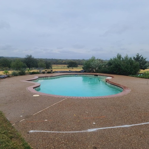 a pool in a concrete paved area